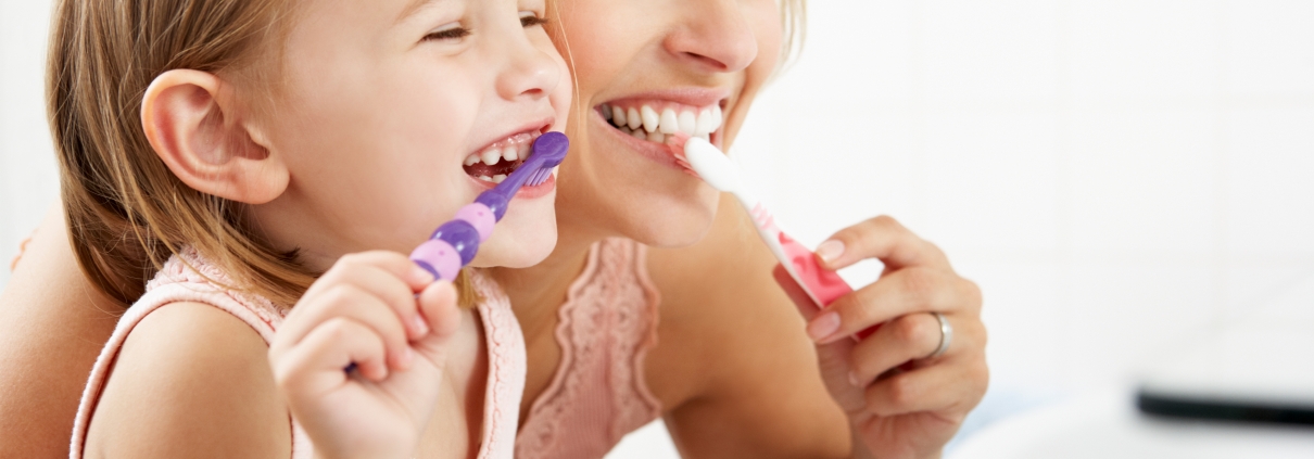 Mother and Daughter Brushing Teeth